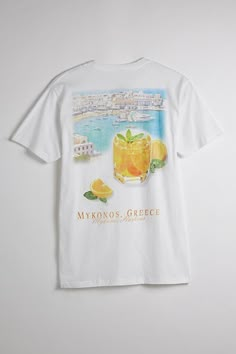 Cotton jersey t-shirt with graphic prints at the front and back. Standard fit tee with short sleeves and a ribbed crew neck. Features Mykonos Oranges graphic tee Graphic print t-shirt Crew neck Short sleeve Regular fit Content + Care 100% Cotton Machine wash Imported Size + Fit Measurements taken from size Medium Chest: 42" Length: 30" | Mykonos Oranges Graphic Tee in White, Men's at Urban Outfitters Summer Wishlist, Grafic Tees, Men's Graphic Tees, Graphic Tee Style, Stay Fresh, California Style, Media Chest, Barbados, Mens Graphic Tee