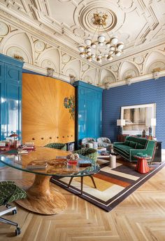 a living room filled with furniture and blue walls