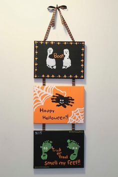 three halloween signs hanging on a wall