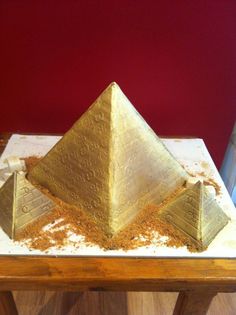 the gold pyramid is covered with sand and spices