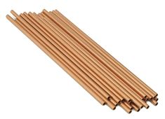 several wooden sticks are lined up on a white surface