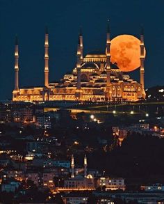 a full moon is seen over the blue mosque in turkey