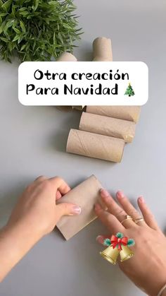 a woman is wrapping christmas presents on the table with her hands and fingers in front of them