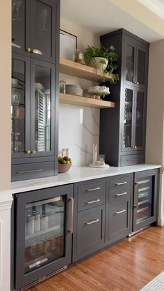 a kitchen with gray cabinets and white counter tops