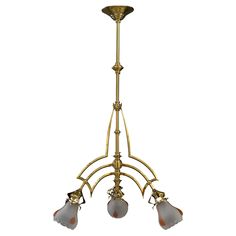 an antique brass chandelier with five glass shades