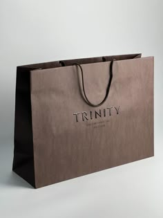 a brown paper bag with the word trinity on it's front and bottom corner