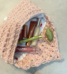 the contents of a crocheted bag are neatly organized