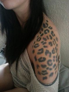 a woman with a leopard print tattoo on her arm