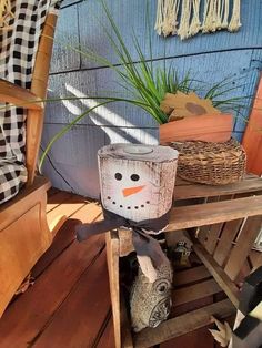 a wooden bench with a snowman head on it