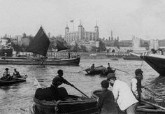 an old black and white photo of people in boats