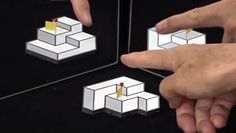 the fingers are pointing at an object in front of two mirrors with different shapes and sizes