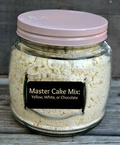 a jar filled with cake mix sitting on top of a wooden table