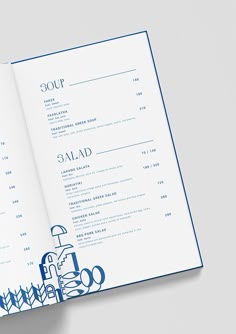 an open menu is shown with blue ink on the inside of it, along with other food and drink items