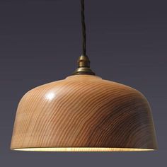 a wooden light hanging from a ceiling with a cord attached to the top of it