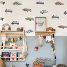 a child's room with cars on the wall and toys hanging from the shelves