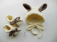 two crocheted stuffed animals sitting next to each other on a white table top