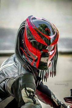 a person wearing a motorcycle helmet and leather jacket