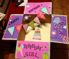 a birthday card is displayed on the floor in front of a table with a cake