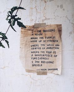 a piece of paper that has been pinned to the side of a wall with writing on it