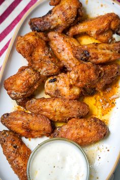 chicken wings on a plate with ranch dressing