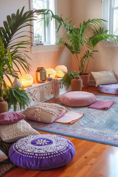 a room with many pillows on the floor and plants in the window sill behind them