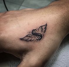 a person's hand with a tattoo on it