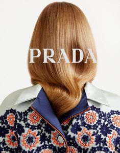 the back of a woman's head with the word prada over it