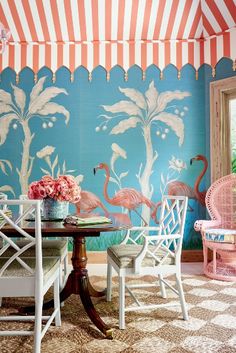 a dining room with flamingos painted on the wall