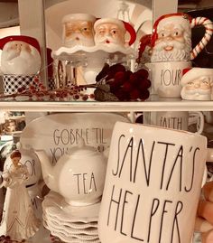 santa's helper mugs and other christmas decorations on display in a store