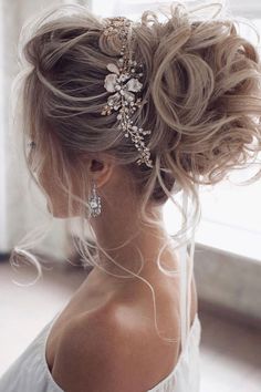 a woman with blonde hair wearing a wedding hairstyle