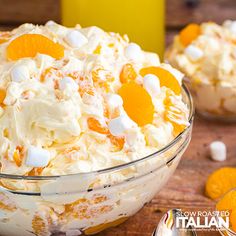 a close up of a bowl of food with oranges and marshmallows