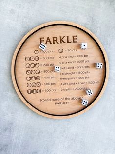 a wooden board with dices on it and the words farkle written in black