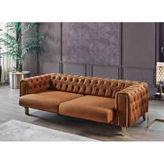 a brown leather couch sitting on top of a wooden floor