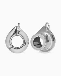 pair of silver plated earrings with circular design on the front and back ends, set against a white background