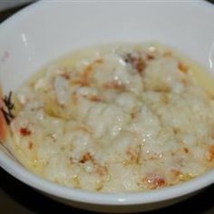 a white bowl filled with food on top of a table