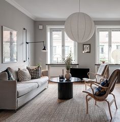 a living room filled with furniture and lots of windows