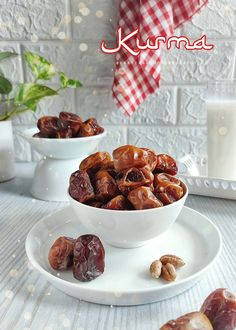 two white bowls filled with raisins on top of a table