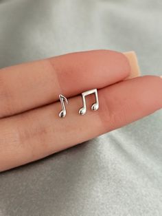 Musical notes stud earrings. These sterling silver musical notes earring studs are the perfect choice for any music lover looking to add a touch of musical charm to their daily look. Minimalist design, crafted from high quality, hypoallergenic sterling silver, these earrings are light and comfortable for all day wear without causing irritation or discomfort to sensitive skin, making them the ideal gift for any musician or music enthusiast. Finish: platinum  or 18k gold  plated over sterling silv Music-themed Silver Earrings, Earrings Aesthetic Stud, Music Note Earrings, Music Earrings, Daily Earrings, Note Music, Silver Butterfly Earrings, Dinosaur Earrings, Stud Earrings Gold