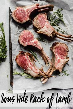 raw lamb chops laid out on parchment paper with rosemary sprigs in the background