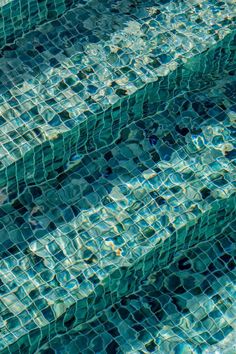 an empty swimming pool with clear blue water