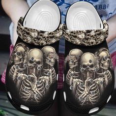 a pair of shoes with skulls and chains on them