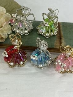 four different colored glass beaded angel ornaments