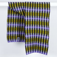 a purple and black checkered scarf hanging on a wall