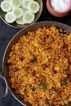 a pan filled with rice and vegetables next to other dishes