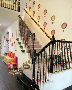 the stairs are decorated with festive garlands and ornaments on them, along with other decorations