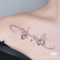 two butterflies on the back of a woman's shoulder, with stars in the background