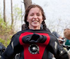 a woman in a scuba suit smiling for the camera