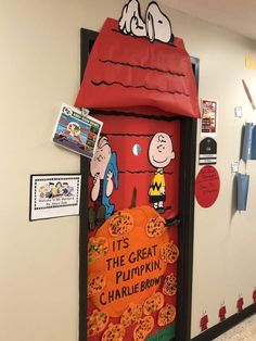 the door to charlie brown's classroom is decorated with peanuts and his pumpkins