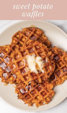 two waffles on a plate with butter and syrup