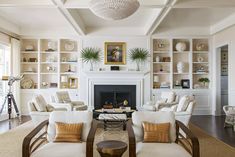 a living room filled with furniture and a fire place in front of a white fireplace